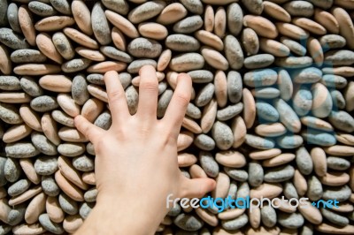 Hand On Stone Wall Stock Photo