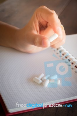 Hand On White Pill Medicine Stock Photo