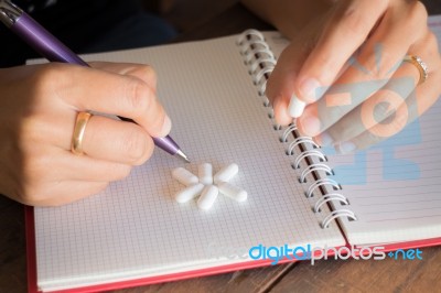 Hand On White Pill Medicine Stock Photo