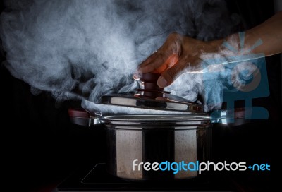 Hand Open Hot Steam Pot Stock Photo