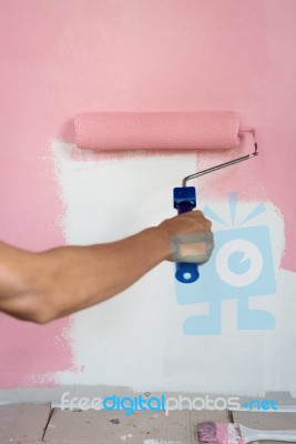 Hand Painting Wall With Paint Roller Stock Photo