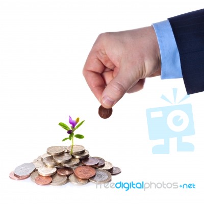 Hand Puts A Penny To A Heap Of British Coins Stock Photo