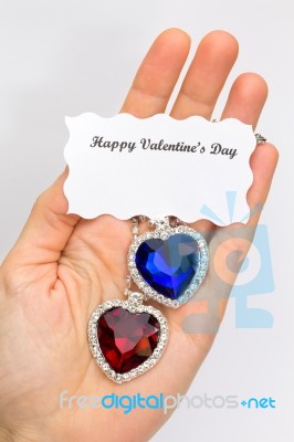 Hand Showing Red And Blue Jewelry Hearts For Valentine Stock Photo