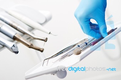 Hand Taking Dental Instruments Stock Photo