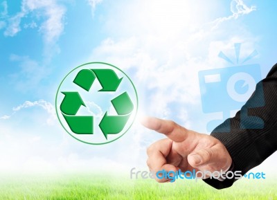 Hand Touching Recycle Sign Stock Photo