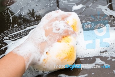 Hand Washing Brown Car With Blue Sponge And Bubbles Stock Photo