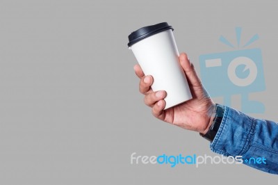 Hand With A Cup On Gray Background Stock Photo