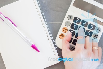 Hand With Calculator And Notepad Stock Photo