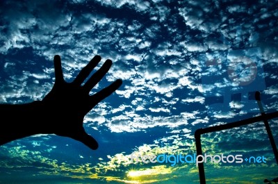 Hand With Clouds On A Dark Day When Sun Was Just About To Set Stock Photo