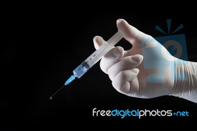 Hand With Syringe Stock Photo