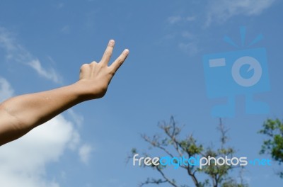 Hand With Two Fingers Up In The Peace Or Victory Symbol Stock Photo