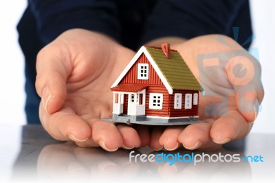 Hands And Small House Stock Photo