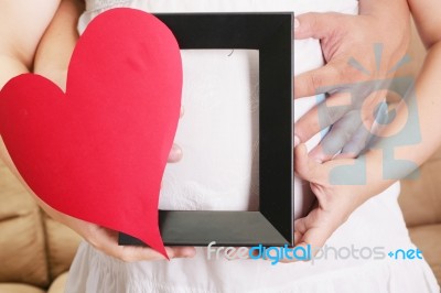 Hands Embracing A Pregnant Woman Belly With Her Hands Holding A Stock Photo