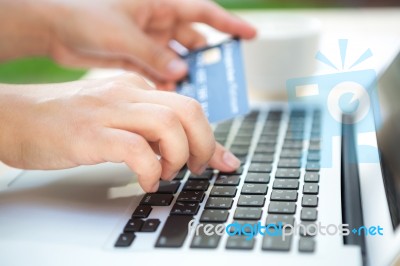 Hands Holding A Credit Card And Using Laptop Computer For Online… Stock Photo