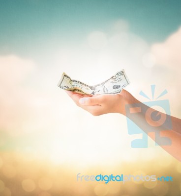 Hands Holding Us Dollars Note With Natural Background Stock Photo