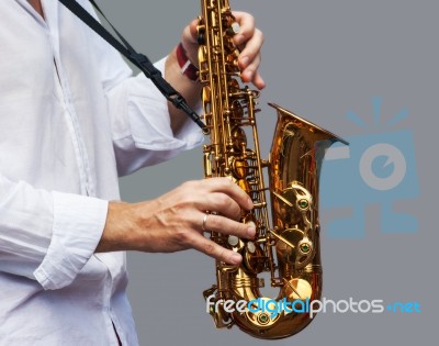 Hands Of A Musician With The Saxophone Stock Photo