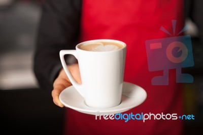 Hands Of Waiter Serving A Cup Of Cappucino Stock Photo