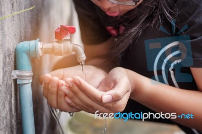 Hands Of Watering The Faucet Stock Photo