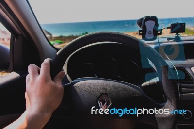 Hands On The Wheel By The Beach Stock Photo