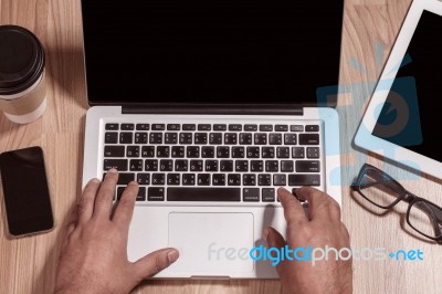 Hands Typing On A Notebook Stock Photo