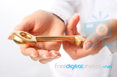 Hands With A Gold Key Stock Photo