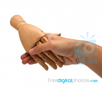 Handshake Between A Human Hand And A Wooden Hand Stock Photo