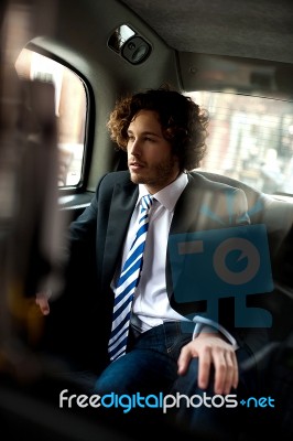 Handsome Business Executive Inside Taxi Cab Stock Photo