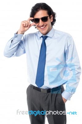 Handsome Businessman Adjusting Sunglasses Stock Photo