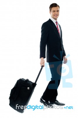 Handsome Businessman Dragging Trolley Bag Stock Photo