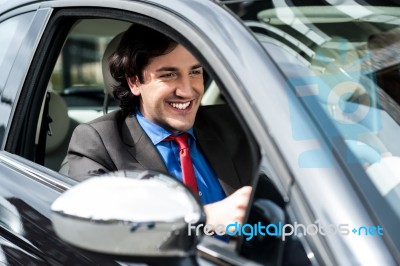 Handsome Businessman Driving A Luxurious Car Stock Photo