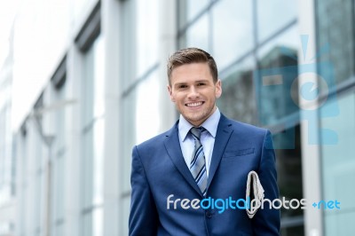 Handsome Businessman Holding A Newspaper Stock Photo