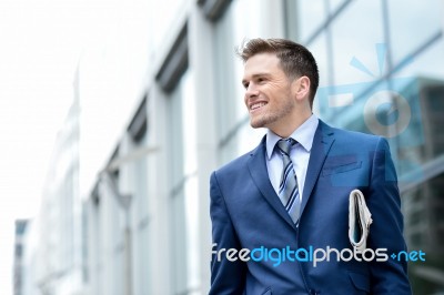 Handsome Businessman Holding A Newspaper Stock Photo