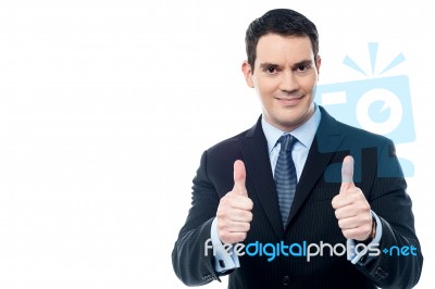 Handsome Businessman Holds His Thumbs Up Stock Photo