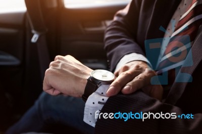 Handsome Businessman Looking On Wrist Watch In Car Stock Photo