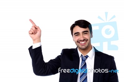 Handsome Businessman Pointing At Something Stock Photo