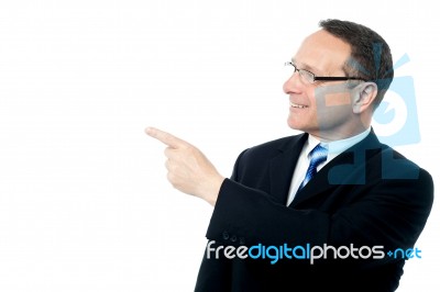 Handsome Businessman Pointing Away Stock Photo