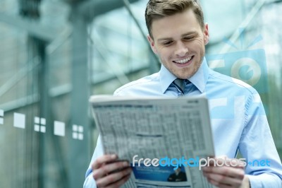 Handsome Businessman Reading A Newspaper Stock Photo