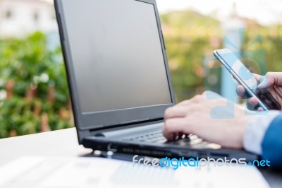 Handsome Businessman Wearing Suit And Using Modern Laptop Outdoo… Stock Photo