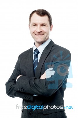 Handsome Businessman With Folded Arms Stock Photo