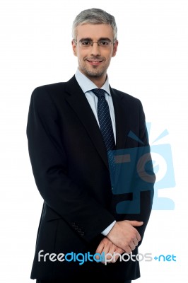 Handsome Businessman With Hands Together Stock Photo