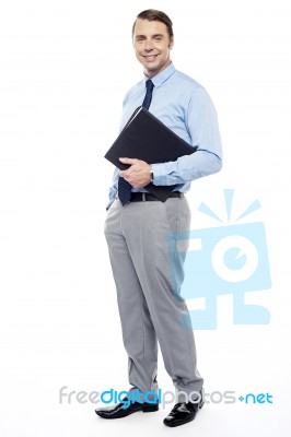 Handsome Confident Businessperson Holding File Folder Stock Photo