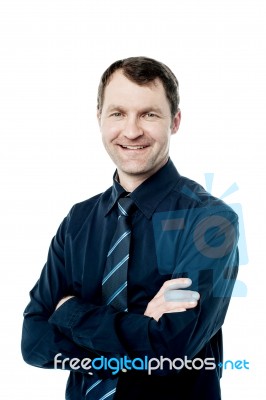 Handsome Corporate Man With Folded Arms Stock Photo