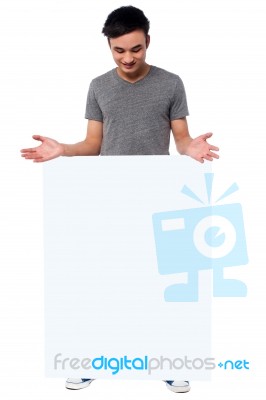 Handsome Guy Behind Blank Ad Board Stock Photo