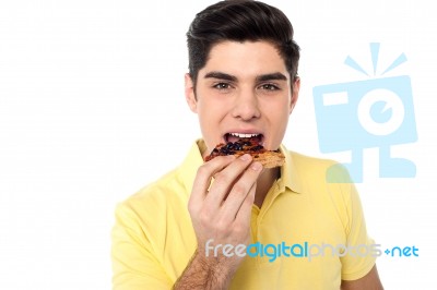 Handsome Guy Enjoying Yummy Pizza Slice Stock Photo