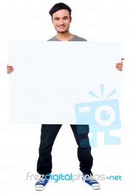 Handsome Guy Holding Blank Ad Board Stock Photo