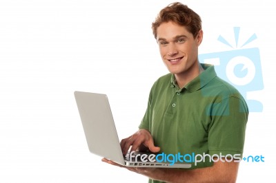 Handsome Guy Operating Laptop Stock Photo