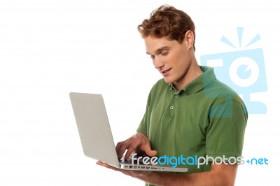 Handsome Guy Operating Laptop Stock Photo