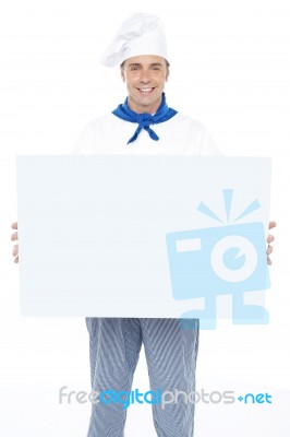 Handsome Male Chef Holding Ad Board Stock Photo