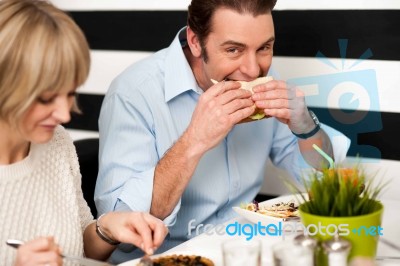 Handsome Male Enjoying His Delicious Sandwich Stock Photo