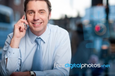 Handsome Male Manager Using His Cell Phone Stock Photo